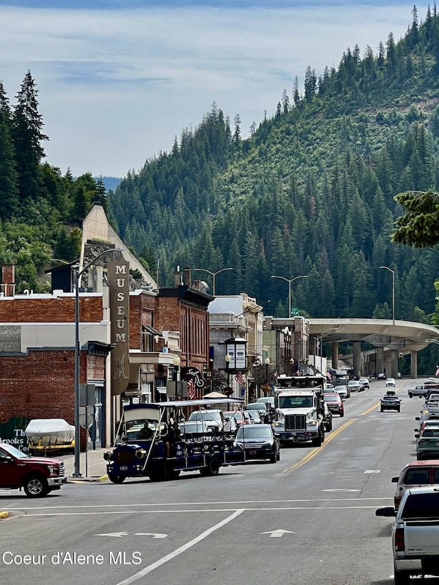 408 High Bank St, Wallace, ID 83873 - view of vehicle parking featuring a wooded view