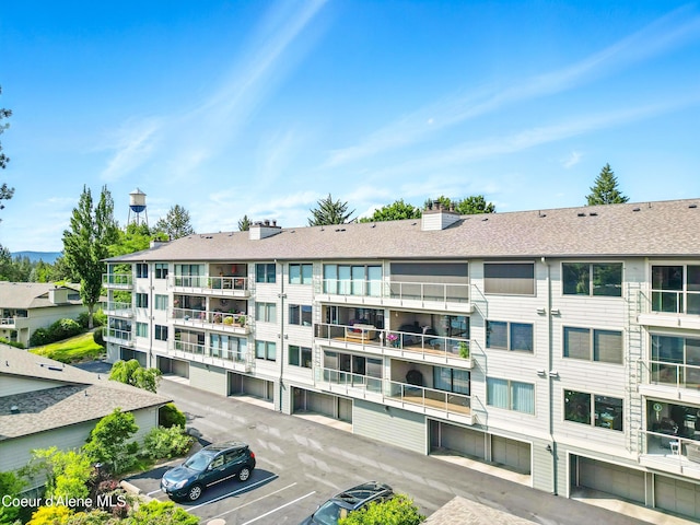 204 E 1st Ave E # 4, Post Falls, ID 83854 - view of apartment building / complex featuring uncovered parking