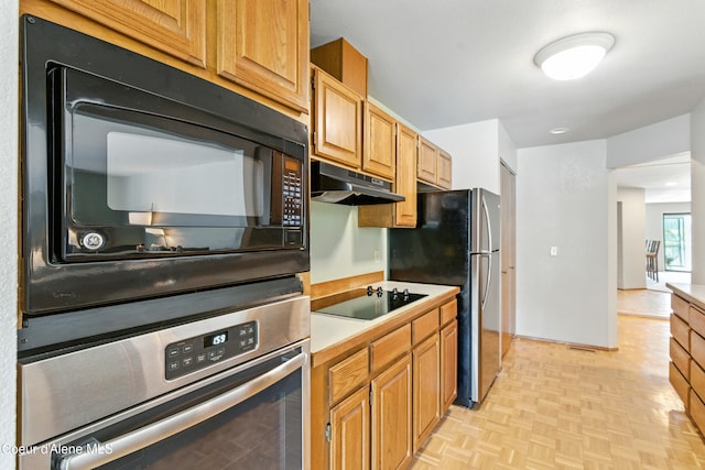 204 E 1st Ave E # 4, Post Falls, ID 83854 - kitchen featuring black appliances, under cabinet range hood, and light countertops