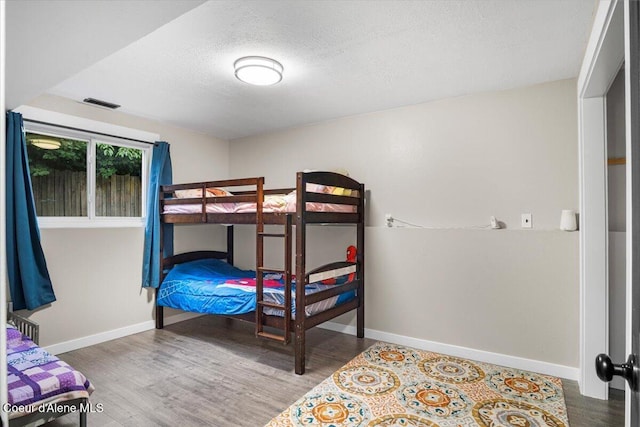 3212 N 7th St, Coeur Dalene, ID 83815 - bedroom featuring wood finished floors and a textured ceiling