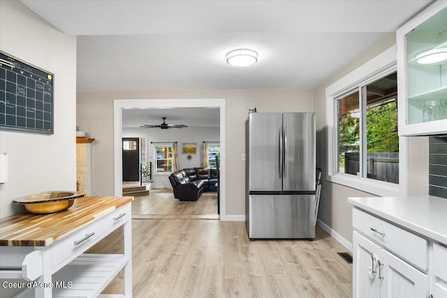 3212 N 7th St, Coeur Dalene, ID 83815 - kitchen featuring freestanding refrigerator, light wood-style flooring, white cabinetry, and plenty of natural light