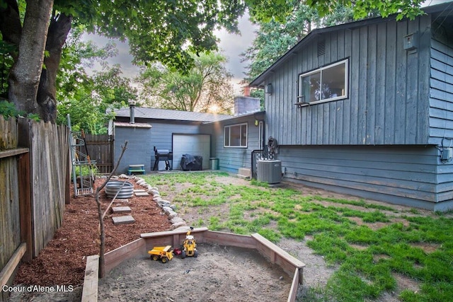 3212 N 7th St, Coeur Dalene, ID 83815 - back of property at dusk featuring an attached garage and a chimney