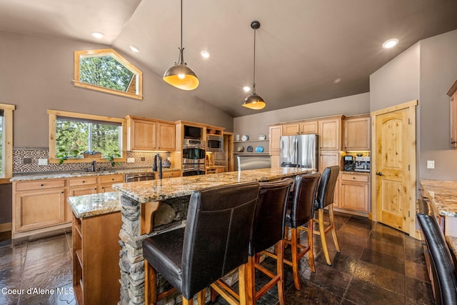 602 Country Club Ln, Pinehurst, ID 83850 - kitchen with appliances with stainless steel finishes, high vaulted ceiling, a kitchen island with sink, decorative backsplash, and light brown cabinets