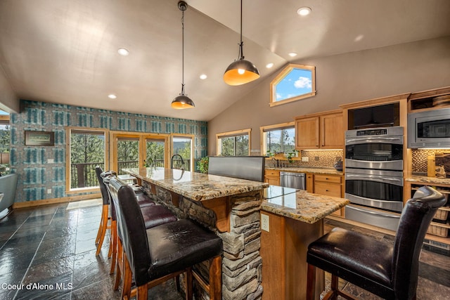 602 Country Club Ln, Pinehurst, ID 83850 - kitchen with appliances with stainless steel finishes, recessed lighting, a warming drawer, stone tile flooring, and backsplash