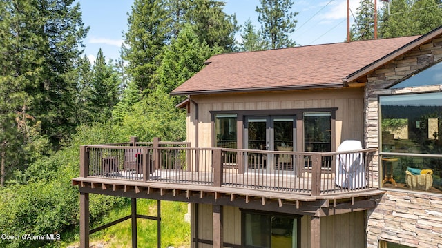 602 Country Club Ln, Pinehurst, ID 83850 - rear view of house with roof with shingles, a wooden deck, and stone siding