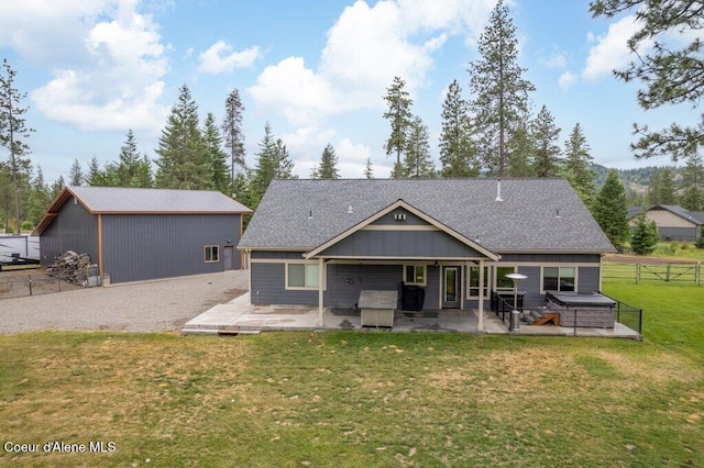 695 W Keva Ln, Athol, ID 83801 - back of house with a jacuzzi, a patio area, and roof with shingles
