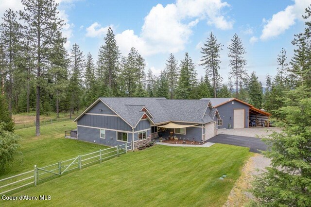 695 W Keva Ln, Athol, ID 83801 - view of front facade with board and batten siding, driveway, and a detached garage