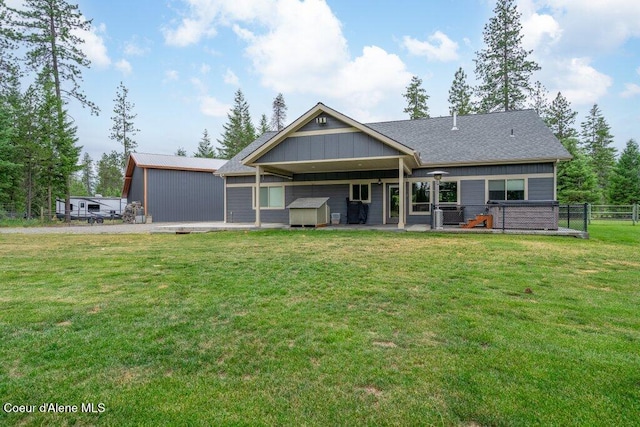 695 W Keva Ln, Athol, ID 83801 - rear view of house featuring a patio area, a storage unit, and board and batten siding
