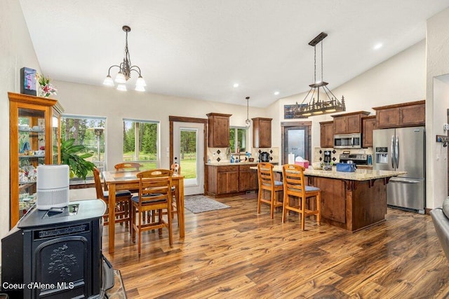695 W Keva Ln, Athol, ID 83801 - kitchen featuring appliances with stainless steel finishes, dark wood finished floors, a center island, lofted ceiling, and pendant lighting