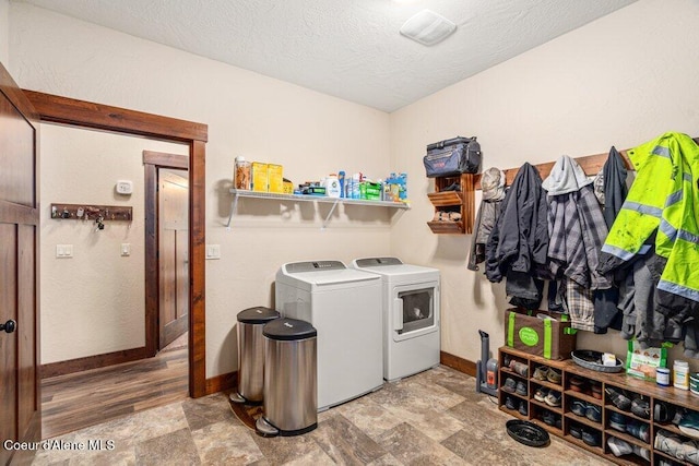 695 W Keva Ln, Athol, ID 83801 - laundry area featuring washer and clothes dryer, stone finish flooring, and a textured ceiling