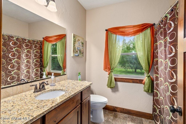 695 W Keva Ln, Athol, ID 83801 - full bathroom with vanity, a textured wall, and stone finish floors