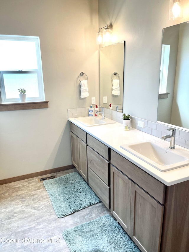 4263 N Donovan Ln, Post Falls, ID 83854 - full bathroom featuring double vanity and baseboards