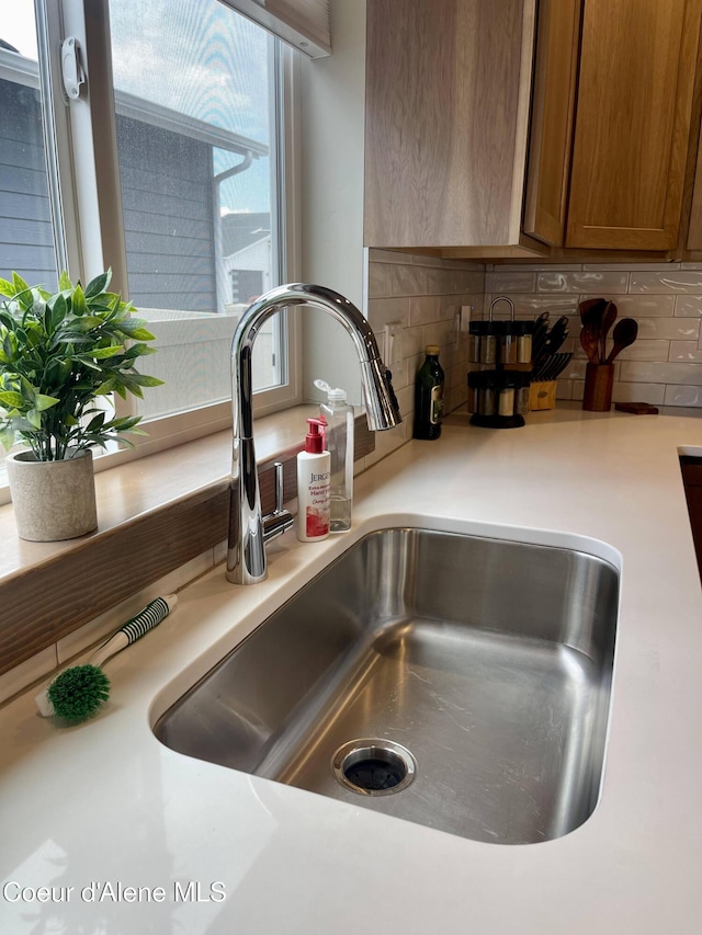 4263 N Donovan Ln, Post Falls, ID 83854 - kitchen view of tasteful backsplash, light countertops, and brown cabinets