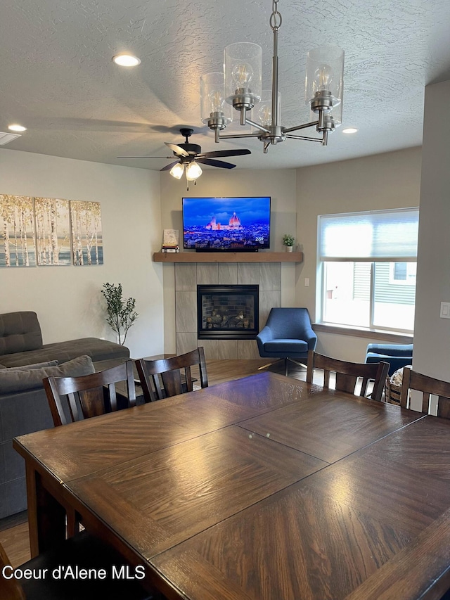 4263 N Donovan Ln, Post Falls, ID 83854 - dining area with a tile fireplace, a textured ceiling, recessed lighting, and ceiling fan