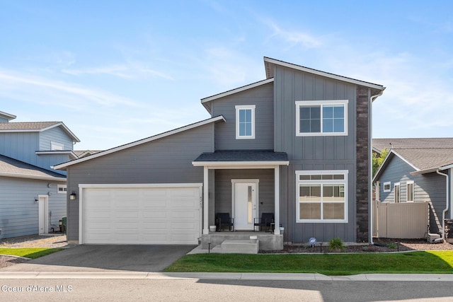 4263 N Donovan Ln, Post Falls, ID 83854 - modern home with board and batten siding, driveway, and a garage