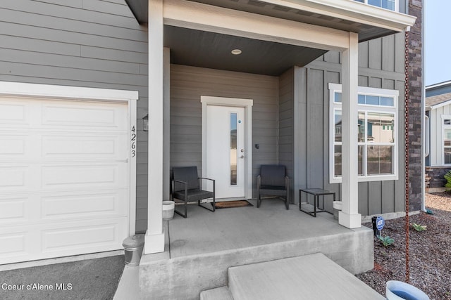 4263 N Donovan Ln, Post Falls, ID 83854 - entrance to property with a garage, board and batten siding, and covered porch