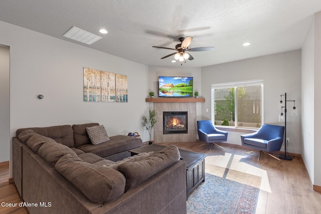 4263 N Donovan Ln, Post Falls, ID 83854 - living area with a fireplace, wood finished floors, ceiling fan, recessed lighting, and a textured ceiling