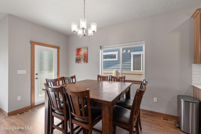 4263 N Donovan Ln, Post Falls, ID 83854 - dining room with plenty of natural light, a chandelier, and light wood-type flooring