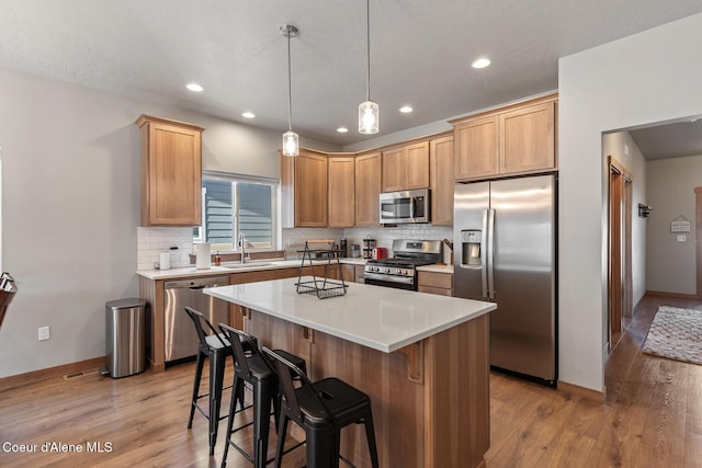 4263 N Donovan Ln, Post Falls, ID 83854 - kitchen featuring appliances with stainless steel finishes, light wood-style floors, backsplash, and recessed lighting