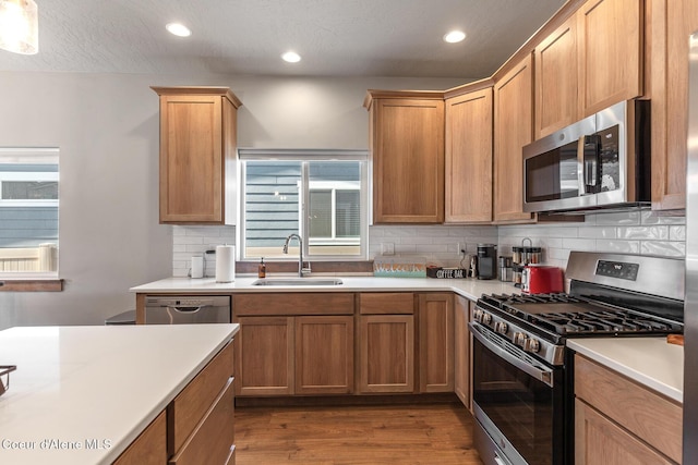 4263 N Donovan Ln, Post Falls, ID 83854 - kitchen with stainless steel appliances, wood finished floors, light countertops, tasteful backsplash, and recessed lighting