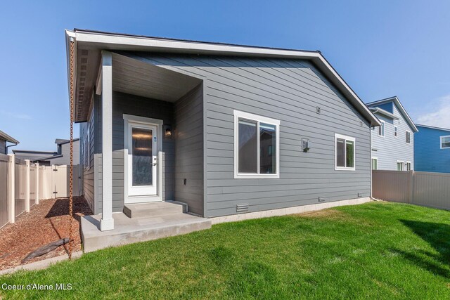 4263 N Donovan Ln, Post Falls, ID 83854 - back of property featuring a fenced backyard and crawl space
