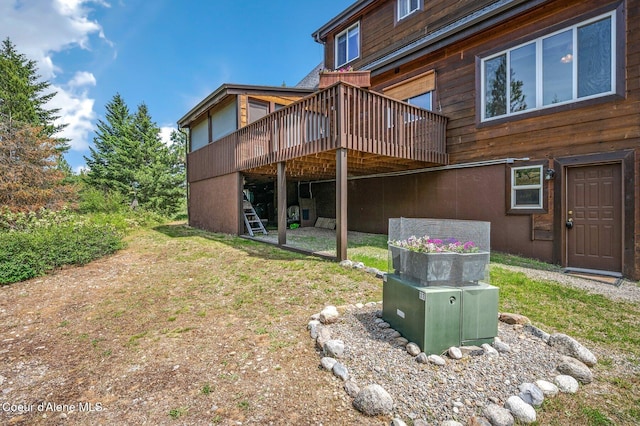 9067 W Coeur D Alene Dr, Spirit Lake, ID 83869 - rear view of property featuring a wooden deck