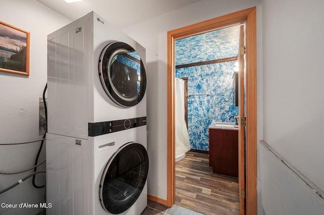 9067 W Coeur D Alene Dr, Spirit Lake, ID 83869 - laundry area with estacked washer and dryer and wood finished floors