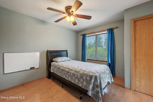 9067 W Coeur D Alene Dr, Spirit Lake, ID 83869 - bedroom featuring wood finished floors and ceiling fan