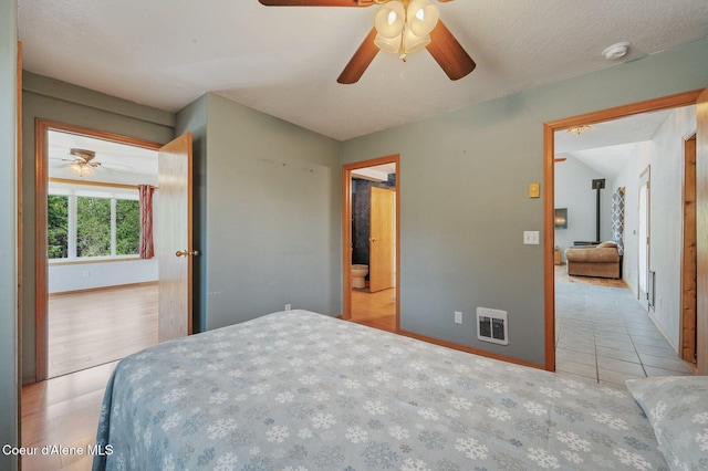 9067 W Coeur D Alene Dr, Spirit Lake, ID 83869 - bedroom featuring tile patterned floors and ceiling fan