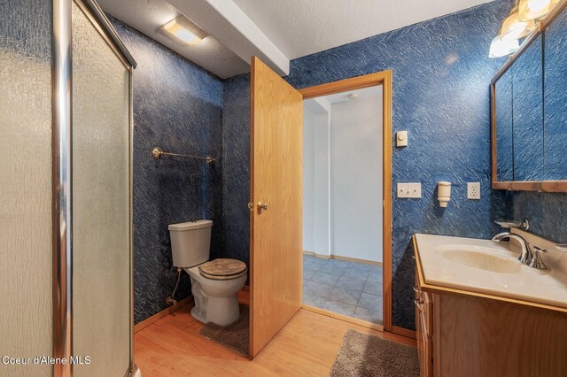 9067 W Coeur D Alene Dr, Spirit Lake, ID 83869 - bathroom with vanity, wood finished floors, and a shower stall