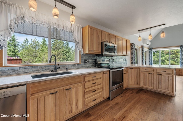 9067 W Coeur D Alene Dr, Spirit Lake, ID 83869 - kitchen featuring stainless steel appliances, a peninsula, a wall mounted AC, tasteful backsplash, and dark wood-style floors