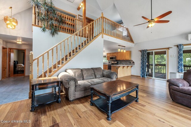 9067 W Coeur D Alene Dr, Spirit Lake, ID 83869 - living area featuring high vaulted ceiling, ceiling fan, stairs, and light wood finished floors