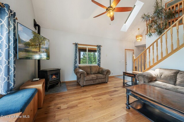 9067 W Coeur D Alene Dr, Spirit Lake, ID 83869 - living area with a ceiling fan, a wood stove, light wood-style floors, a skylight, and stairway