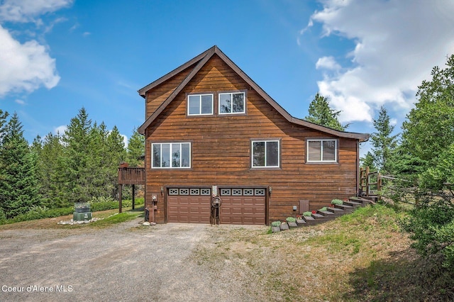 9067 W Coeur D Alene Dr, Spirit Lake, ID 83869 - view of side of property with an attached garage and driveway