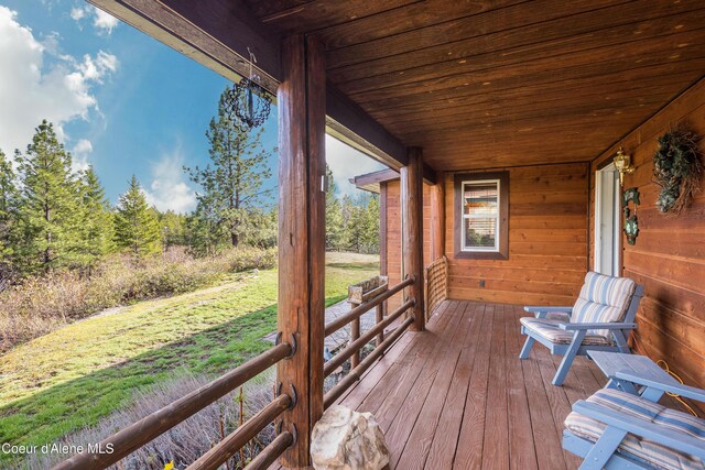9067 W Coeur D Alene Dr, Spirit Lake, ID 83869 - wooden terrace featuring a lawn