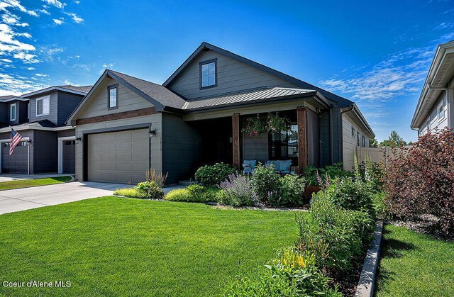 2052 W Bernard Dr, Coeur Dalene, ID 83815 - view of front of home with a front yard, driveway, and a standing seam roof
