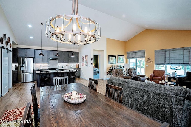 2052 W Bernard Dr, Coeur Dalene, ID 83815 - dining room with high vaulted ceiling, a chandelier, light wood-style floors, and recessed lighting