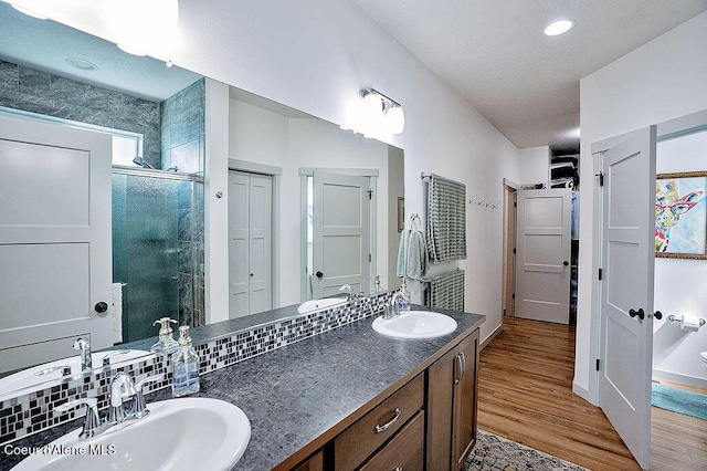 2052 W Bernard Dr, Coeur Dalene, ID 83815 - full bathroom featuring a closet, wood finished floors, double vanity, and a stall shower