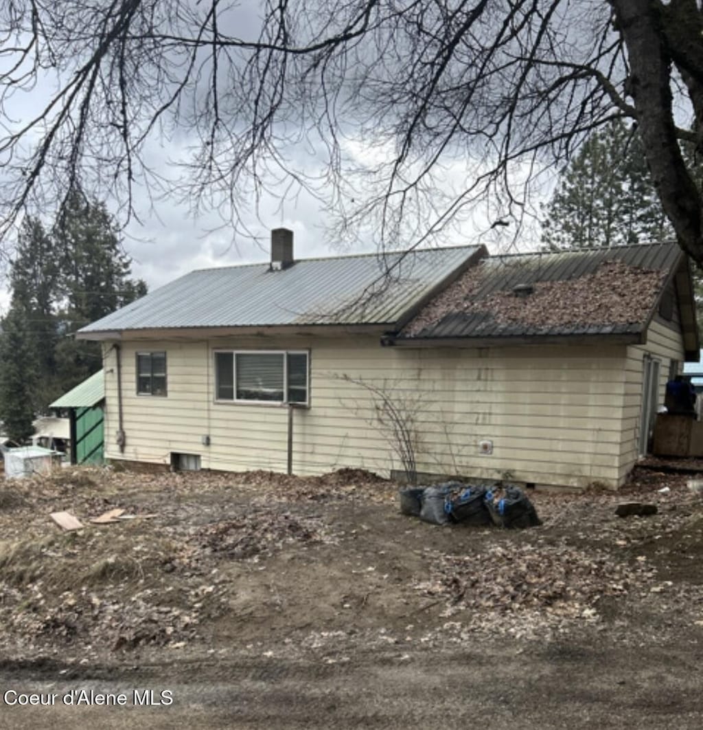 629 S Marian St, Oldtown, ID 83822 - view of property exterior featuring a metal roof and a chimney