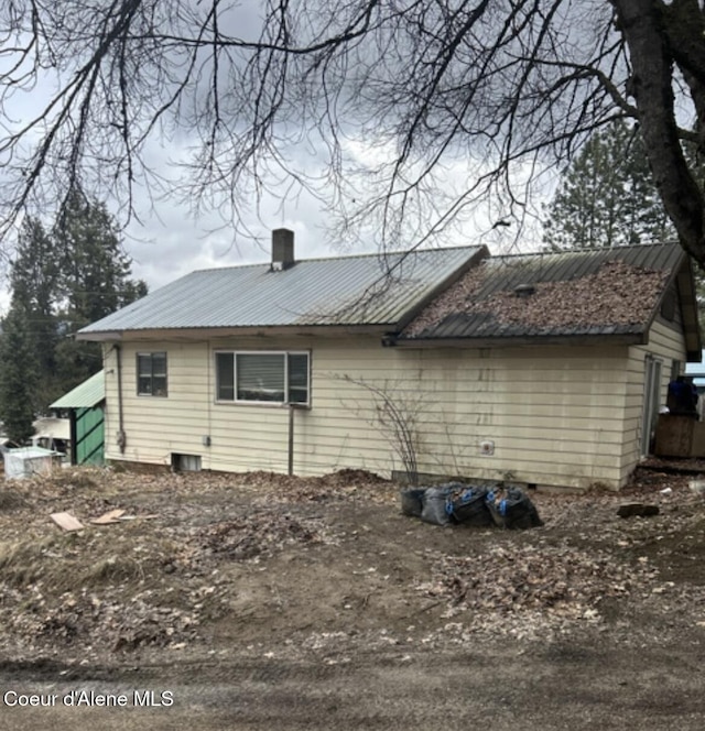 629 S Marion St, Oldtown, ID 83822 - view of property exterior featuring a metal roof and a chimney