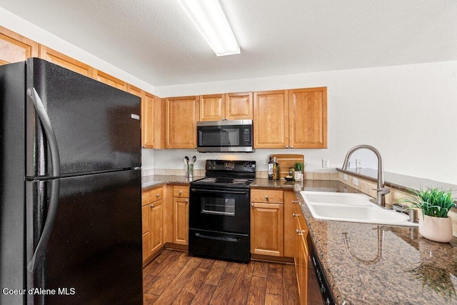 310 N Promenade Loop # 210, Post Falls, ID 83854 - kitchen with black appliances, dark wood-style floors, and brown cabinets