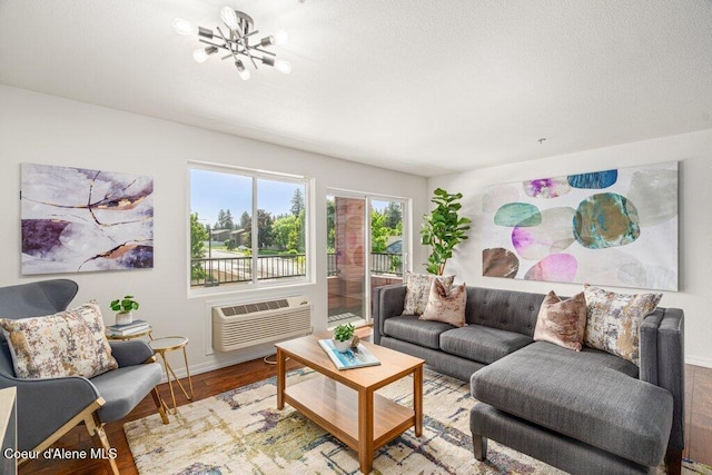 310 N Promenade Loop # 210, Post Falls, ID 83854 - living room featuring a chandelier, wood finished floors, and a wall mounted air conditioner