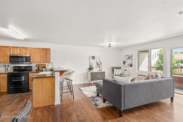 310 N Promenade Loop # 210, Post Falls, ID 83854 - living area featuring dark wood finished floors and a textured ceiling