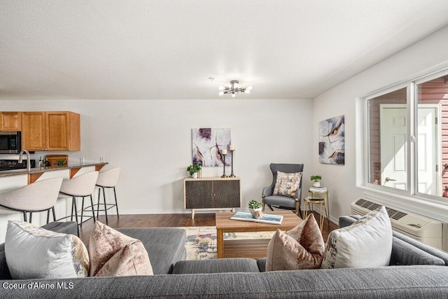 310 N Promenade Loop # 210, Post Falls, ID 83854 - living area featuring wood finished floors, healthy amount of natural light, and a chandelier