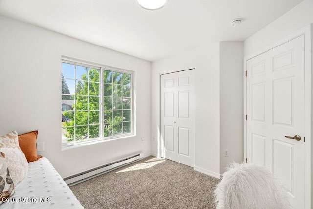 310 N Promenade Loop # 210, Post Falls, ID 83854 - carpeted bedroom with baseboard heating, multiple windows, and a closet