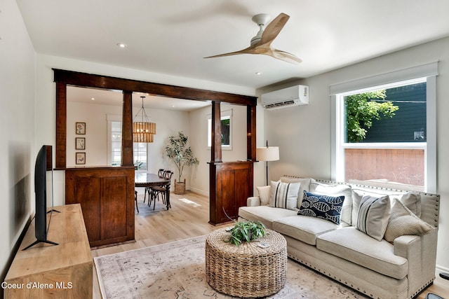 917 N Boyer Ave, Sandpoint, ID 83864 - living area with a wall mounted air conditioner, light wood finished floors, a chandelier, and ceiling fan