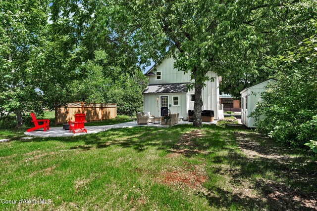 917 N Boyer Ave, Sandpoint, ID 83864 - view of green lawn featuring a patio area, outdoor lounge area, and an outbuilding