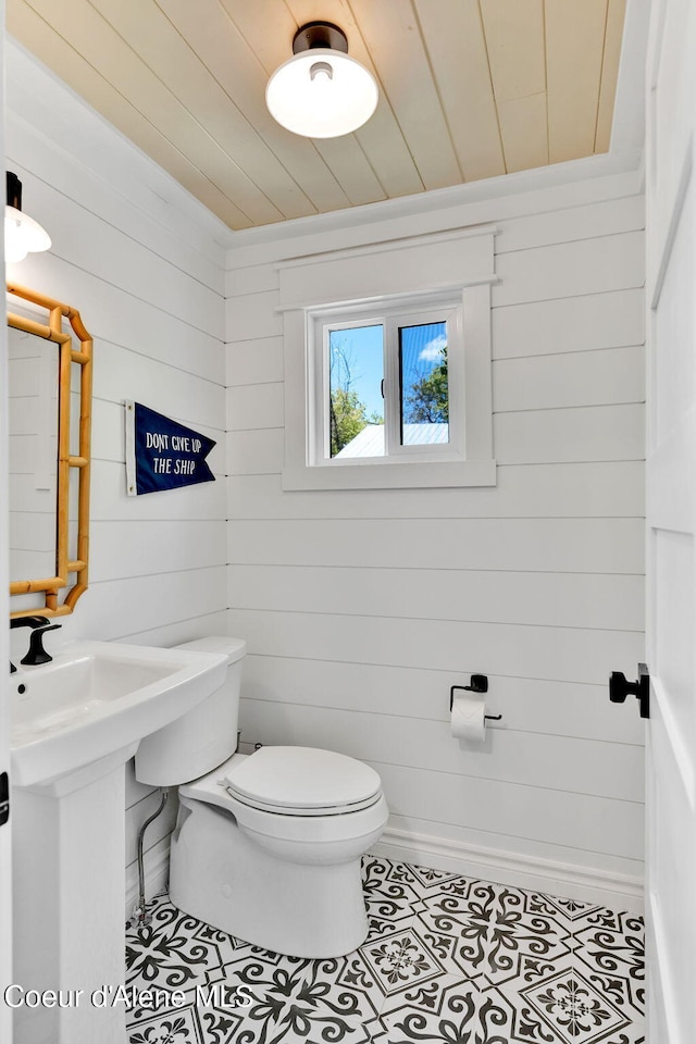 917 N Boyer Ave, Sandpoint, ID 83864 - half bath featuring wooden ceiling, wood walls, and tile patterned floors