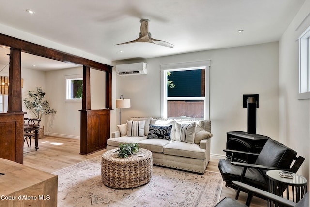917 N Boyer Ave, Sandpoint, ID 83864 - living area featuring a wall unit AC, ceiling fan, a wood stove, light wood-style floors, and recessed lighting