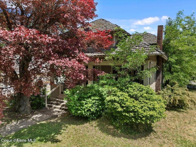 602 N Government Way, Coeur Dalene, ID 83814 - view of side of home with a chimney and a yard